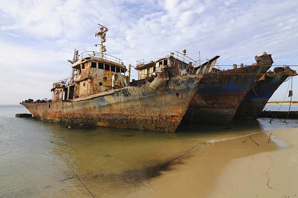 Ship wrecks rusting on the beach of Nouadhibou, one of the largest ship wreck cemeteries worldwide, Mauretania, northwestern Africa