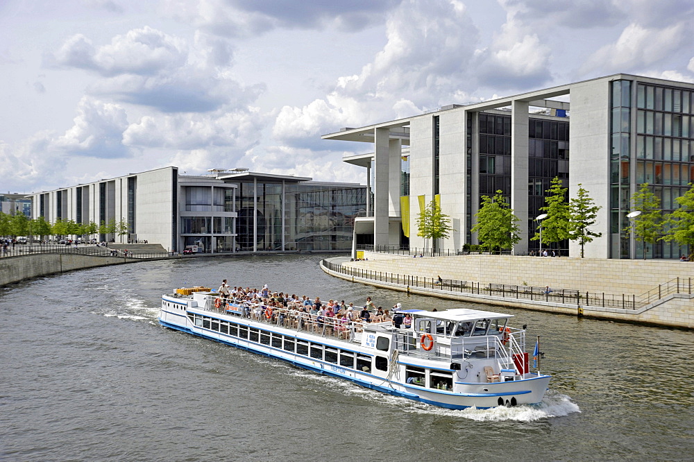 Passenger ship with tourists, Paul-Loebe-Haus building, river Spree at Schiffbauerdamm, Regierungsviertel government district, Berlin, Germany, Europe