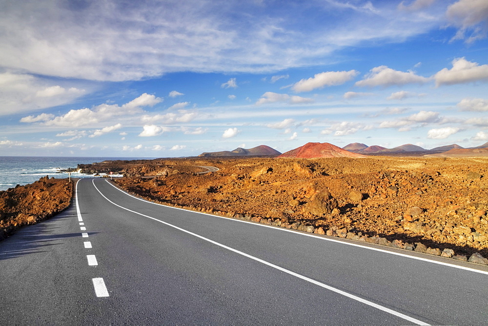 Road on the west coast, in the back the Montanas del Fuego mountains, Lanzarote, Canary Islands, Spain, Europe