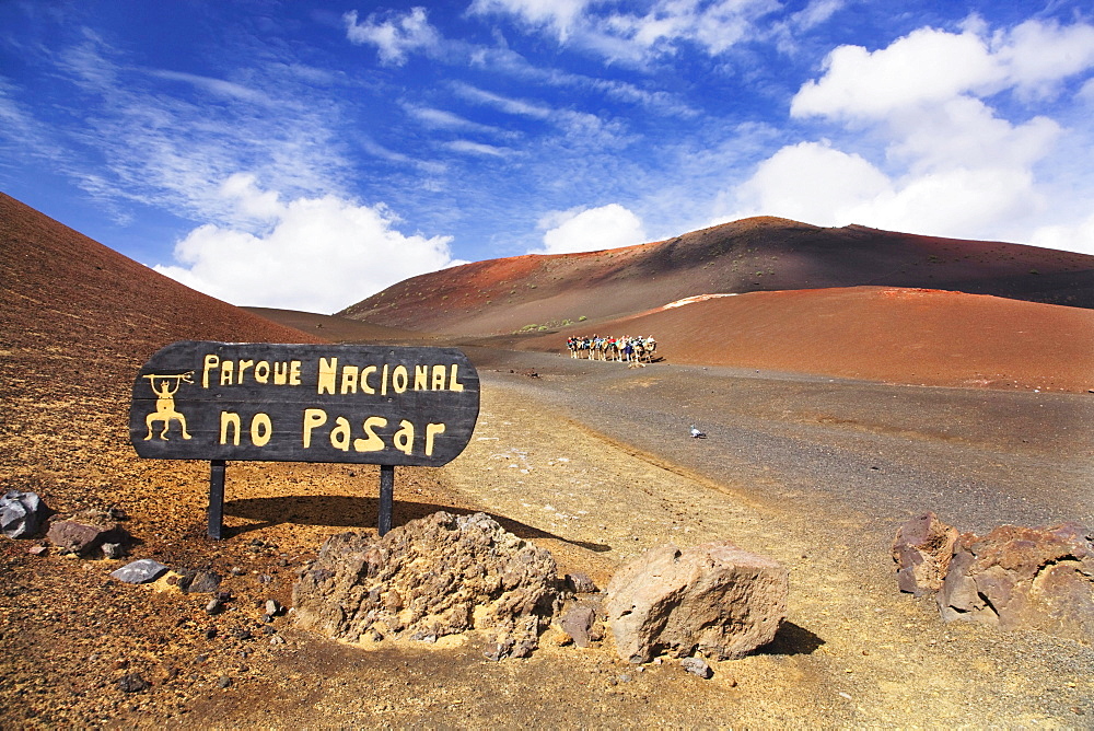 Sign, No Trespassing - National Park, in the back tourists riding dromedaries in the Timanfaya National Park, Lanzarote, Canary Islands, Spain, Europe