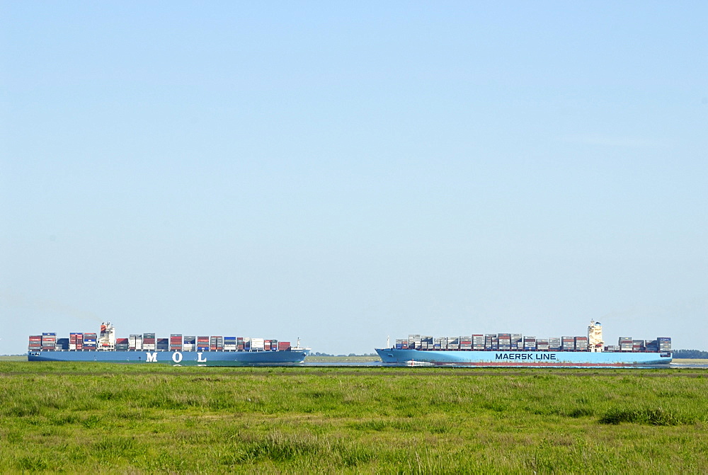 Two container vessels passing one another on the lower Elbe River, Schleswig-Holstein, Germany, Europe