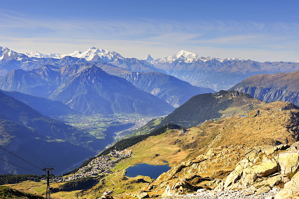 View from Bettmerhorn Mountain, 2872 metres high, down to Bettmeralp with Bettmersee lake and the Rhone Valley with the Pennine Alps on the horizon, Canton of Valais, Switzerland, Europe