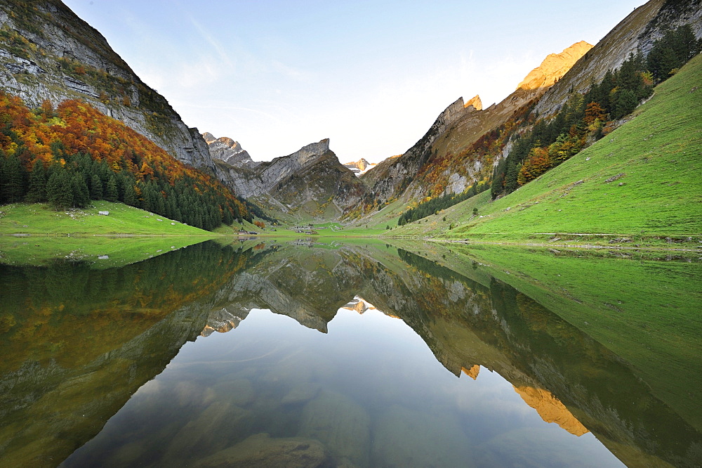 Early morning mood after sunrise looking over Seealp Lake, at 1143 m altitude, towards Rossmad Mountain, 2103 meters high, right behind, Saentis Mountain, to the left, Altmann Mountain, Canton of Appenzell Inner-Rhodes, Switzerland, Europe