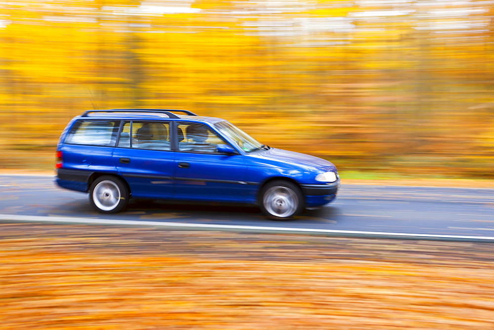 Car driving on a country road in autumn, Hesse, Germany, Europe