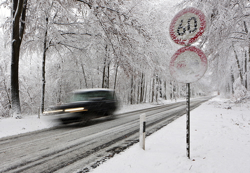 Speed limit of 60 on a snow-covered highway in winter with fast traffic, Hesse, Germany, Europe