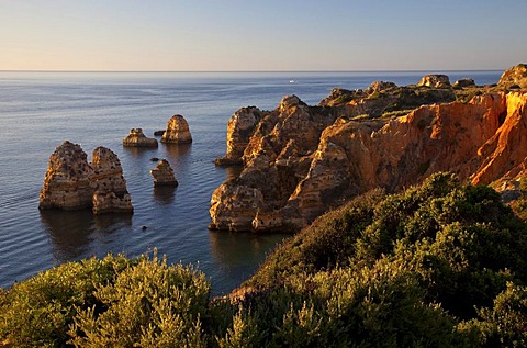 Rugged rocky coastline and cliffs in the early morning light, Lagos, Algarve, Portugal, Europe