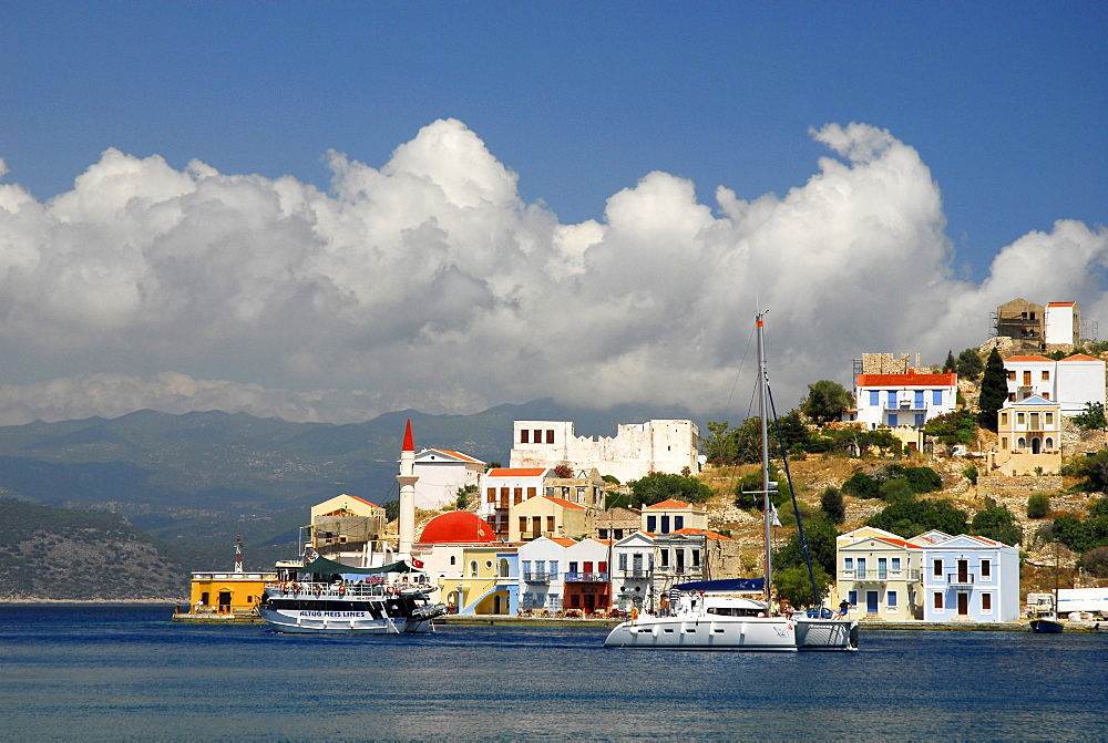 Houses and boats in the bay with the turkish coast at back, town Megisti on Kastelorizo island, Meis, Dodecanese Islands, Aegean, Mediterranean, Greece, Europe