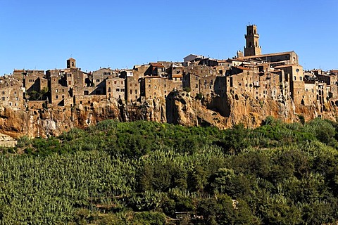 View to medieval limestone town of Pitigliano, situated on rocks raising from a green valley, Maremma, Tuscany, Italy, Europe