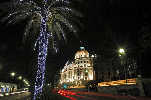 Hotel Negresco on the Promenade des Anglais at Christmas, palm tree with fairy ights, Nice, Departement Alpes Maritimes, Region Provence Alpes Cote d'Azur, Mediterranean, Europe