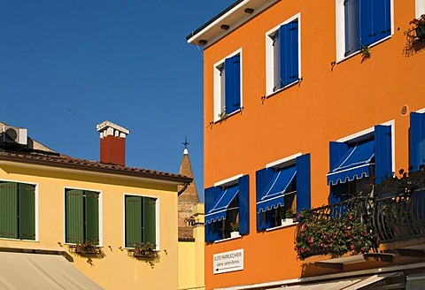 Brightly painted house facades, historic town centre of Caorle, Veneto, Italy, Europe