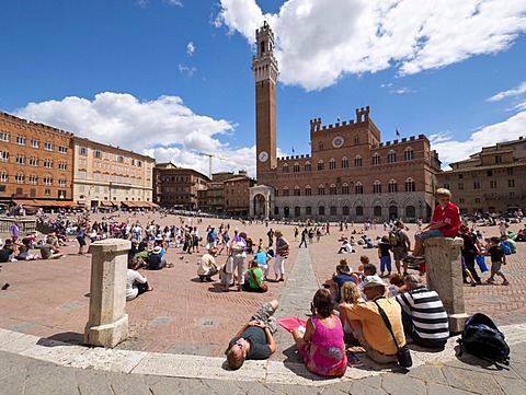 Tourists visiting Il Campo, the central square in the historic town centre of Siena, Tuscany, Italy, Europe