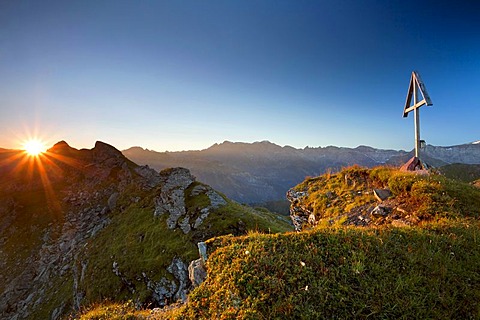 Mountain cross and sunrise in the canton of Glarus, Swiss Alps, Switzerland, Europe