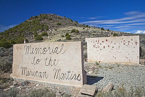 A memorial to Mexican priests who were martyred during the Cristero rebellion in Mexico in the late 1920s, the memorial depicts a wall used by a firing squad, with busts of the martyrs on the hillside above, San Luis, Colorado, USA