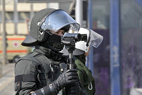 Police officer with a video camera filming his colleagues on duty at a NPD rally in Ulm, Baden-Wuerttemberg, Germany, Europe