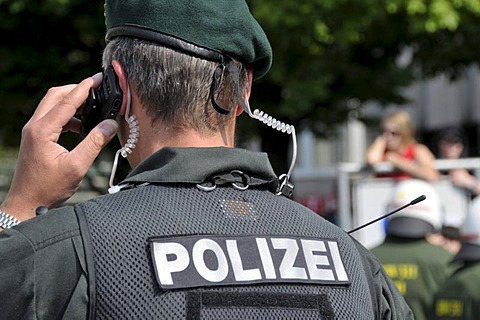 Policeman from the Evidence and Arrest Unit, BFE, using a mobile phone at a NPD rally in Ulm, Baden-Wuerttemberg, Germany, Europe