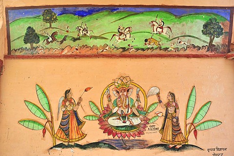 Painting on a wall with images of riders on a tiger hunt and Ganesha, the elephant god, on his throne flanked by magnificently dressed women, Bundi, Rajasthan, India, Asia