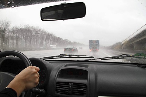 View through the windshield of a moving car at poor sight caused by heavy rain, Germany