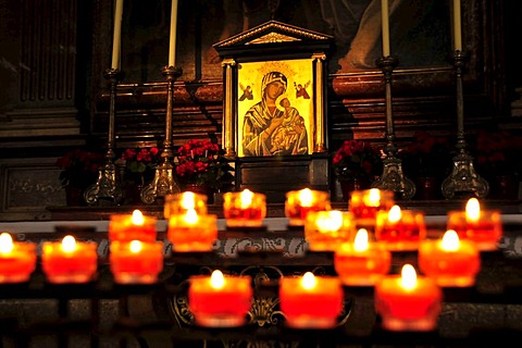 Candles in front of an icon of Our Lady in Salzburg Cathedral, Salzburg, Salzburg, Austria, Europe