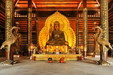 Golden Buddha statue at the construction site of the Chua Bai Dinh pagoda, one of the largest pagodas in Southeast Asia, near Ninh Binh, Vietnam, Southeast Asia