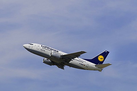 Boeing 737-500 airline from Lufthansa climbing in front of cirrostratus clouds