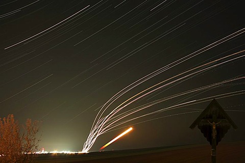 Airplane trails, star trails, the rising moon