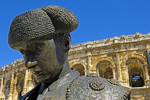 Arenes de Nimes Roman amphitheatre and bullfighter statue, Nimes, Gard, Bouches-Du-Rhone, France, Europe