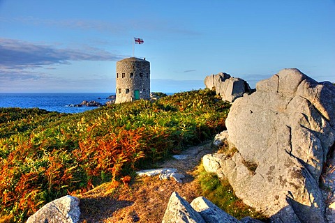 Martello towers, watch and guard towers from the 17th century found along the coastline, here Tower No. 5 at Pembroke Bay in the northeast of Guernsey, Channel Islands, Europe