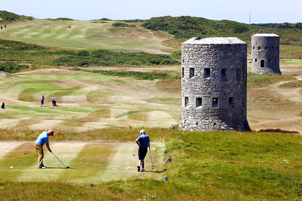 Royal Guernsey Golf Club, Martello towers, watch towers and fortified towers built in the 17th century, next to the fairways, at Pembroke bay in the northeast of the Channel Island of Guernsey, Europe