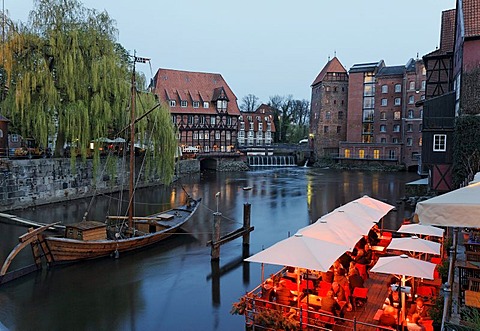 Historical salt port on the Ilmenau river, evening mood, illuminated restaurant terraces, Lueneburg, Lower Saxony, Germany, Europe