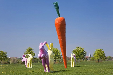 Bunny sculptures arranged around a carrot sculpture, Scharnhauser Park district, Ostfildern, Baden-Wuerttemberg, Germany, Europe