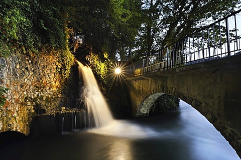 Small illuminated waterfall at the outflow channel of the power station below the mill and next to the Rheinfall waterfalls, Canton Schaffhausen, Switzerland, Europe