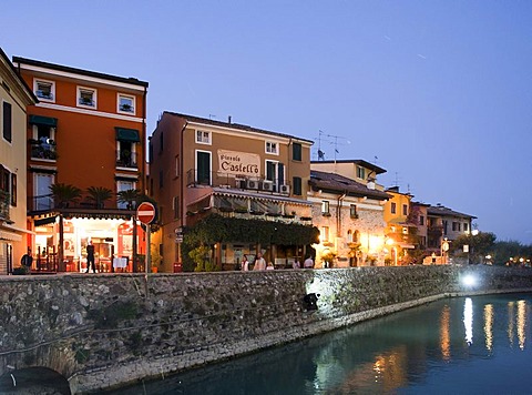 Tourists sitting in a restaurant in Sirmione village, Lombardy, Italy, Europe
