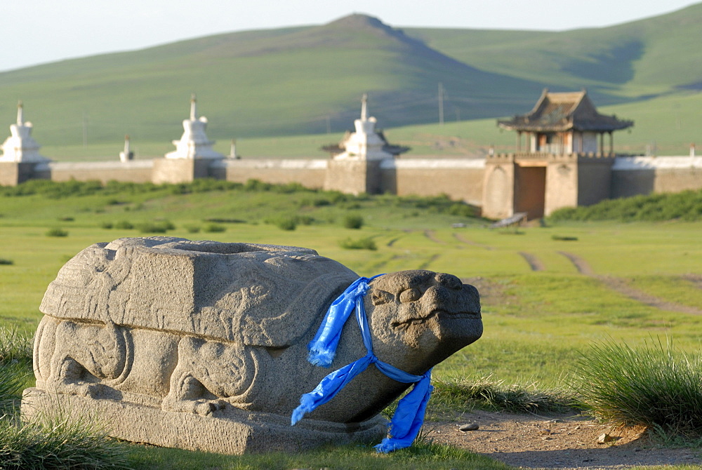 Stone turtle with a blue ribbon, Khata, guard, located in front of the stupa of the outer wall of the Erdene Zuu Khiid Monastery, Karakorum, Kharkhorin, Oevoerkhangai province, Mongolia, Asia