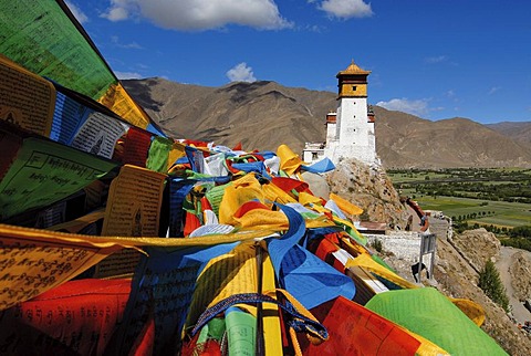 Prayer flags flying above the Yarlung valley on Yumbulagang Palace, first and oldest fortress in Tibet, Himalayas, Central Tibet, Tibet, China, Asia