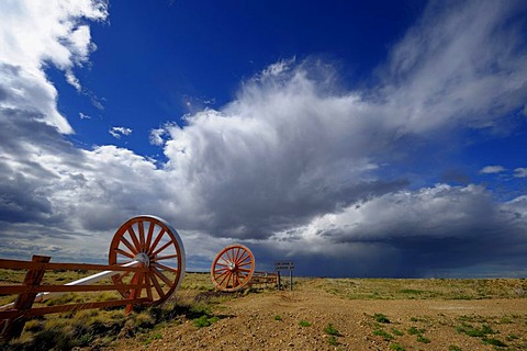 Estancia entrance with wagon wheels and a dramatic sky, Monte Leon National Park, Rio Gallegos, Patagonia, Argentina, South America