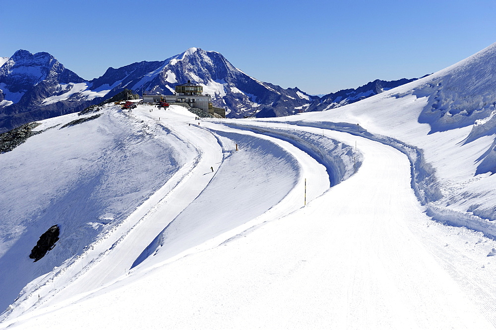 Mountain station on Mt. Mittelallalin with ski slope in the foreground, Saas Fee, Valais, Switzerland, Europe