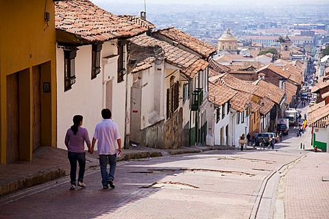 Couple walking down sloping street, Bogota, Colombia, South America