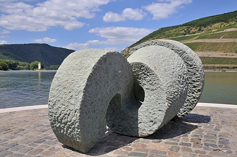 "Poseidon" sculpture made of Anroecht dolomit created by the artist Jo Kley, located where the Nahe river flows into the Rhine river, Maeuseturm tower at the back, Upper Middle Rhine Valley UNESCO World Heritage site, Bingen, Rhineland-Palatinate, Germany