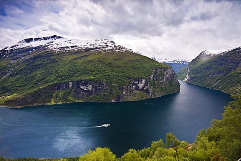 Panoramic view of the Geiranger Fjord from the eagle eyes view ornesvingen with the waterfalls "The Seven Sisters" and the ferry to Hellesylt, Norway, Scandinavia, Europe