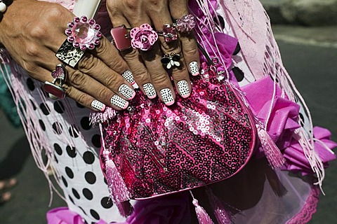 Close-up of transvestite's hands with painted finger nails, rings and handbag, Banda de Ipanema Parade, Carnival in Rio de Janeiro, Brazil, South America