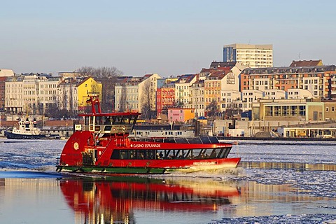 A harbor ferry on the wintery Elbe river in Hamburg's port, Landungsbruecken jetties, Hamburg, Germany, Europe