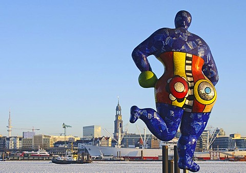 Nana sculpture in front of the tent of the musical The Lion King in the Hamburg harbor, rear view, in the back the St. Michaelis church, Landungsbruecken jetties, Hamburg, Germany, Europe