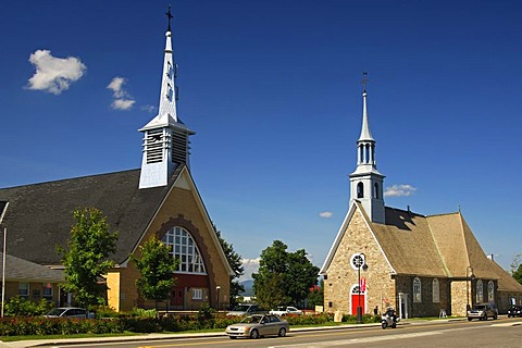 New church, left, and Saint-Pierre-et-Saint-Paul Church, historic monument in the town of St-Pierre-de-l'Ile-d'Orleans on Orleans Island, Quebec, Canada