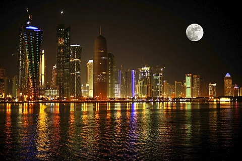 Night shot, Doha skyline with the Tornado Tower, Navigation Tower, Peace Towera, Al-Thani Tower and the moon, Doha, Qatar, Persian Gulf, Middle East, Asia