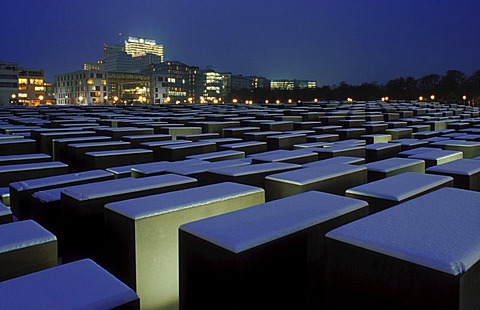 Holocaust Memorial designed by architect Peter Eisenman covered with snow, memorial to the murdered jews of Europe, with a view of the skyline of the Potsdamer Platz square, Tiergarten district, Mitte district, Berlin, Germany, Europe