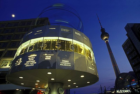 World clock on Alexanderplatz square, TV Tower and moon in the twilight, Mitte district, Germany, Europe