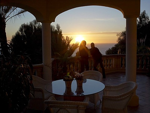 Two women watching the sunset from the terrace of a high quality, stylish apartment, Majorca, Balearic Islands, Spain, Europe