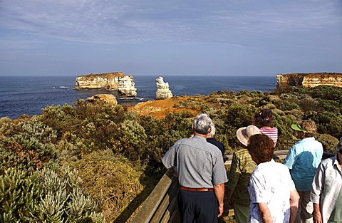 Tourists overlooking the Bay of Isles, Port Campbell National Park, Victoria, Australia