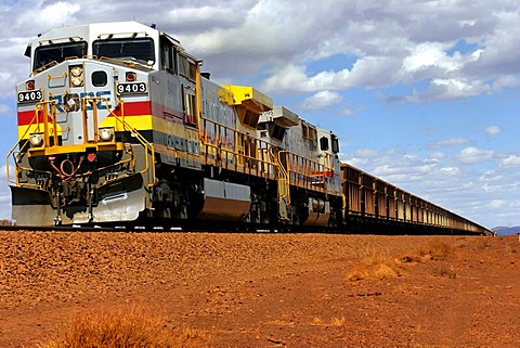 GE Dash9 Diesel Train, approx 6000 horsepower, carting iron ore from Mt Tom Price to Port Dampier, Pilbara, Northwest Australia