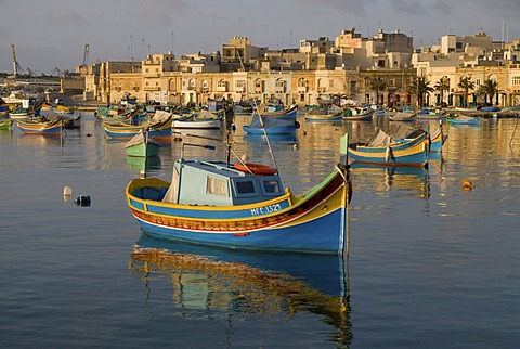 Luzzus, the typical colorful fishing boats of Malta, in Marsaxlokk Harbour, Malta, Europe